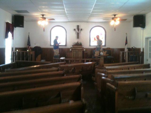 Brother James speaks with someone from the Daily Herald.  You can see how the flood water rearranged our pews in the sanctuary.  An article about us and the community would make front page news in Tuesday's paper.