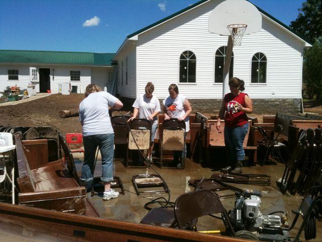 Some of our ladies take their turn at the pressure washer as we tackle the folding chairs.