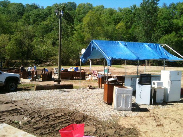 Tuesday, with a tent for additional shade.  Larger pieces have been gathered for either cleaning or hauling away.